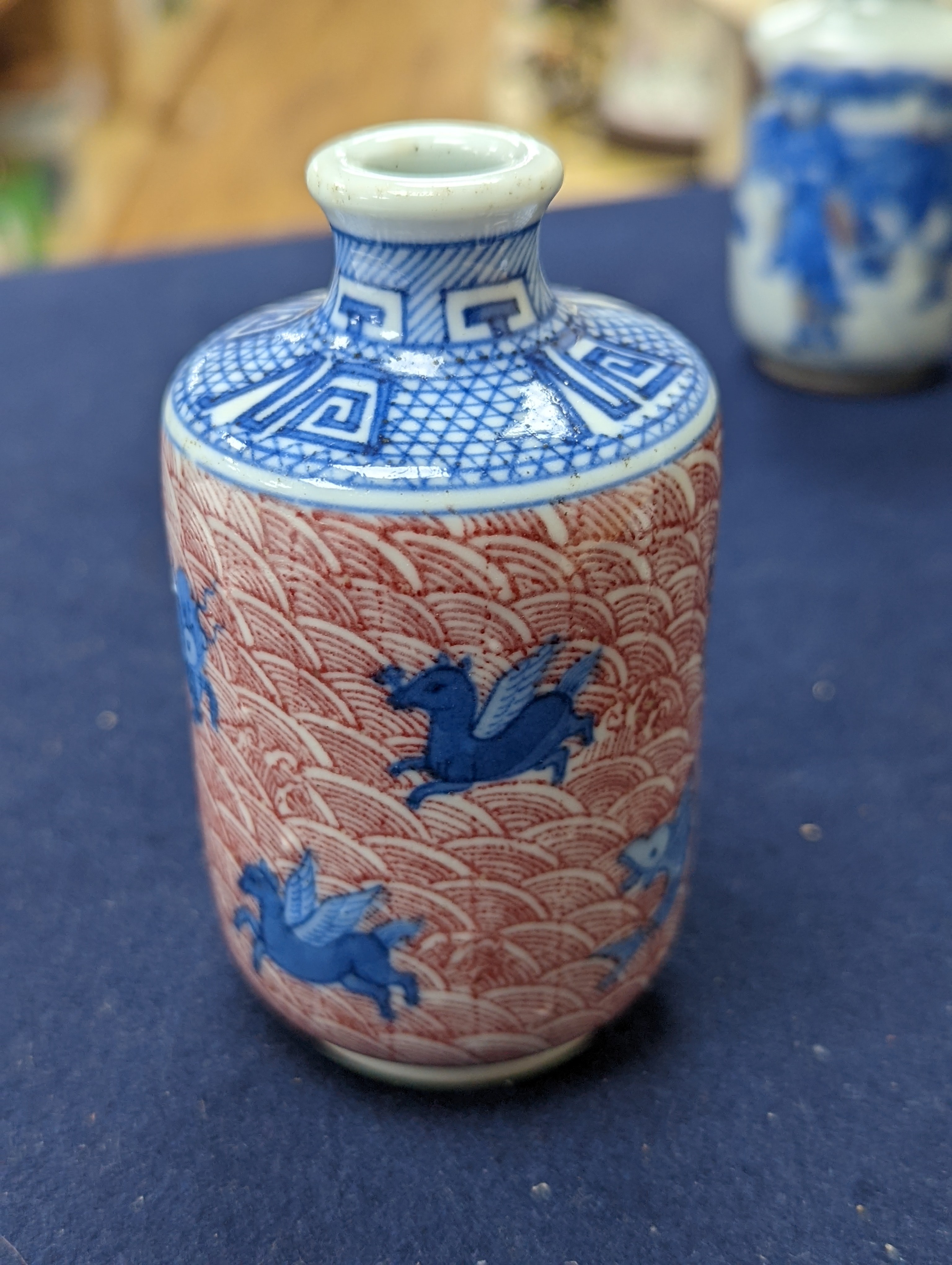 Three Chinese underglaze blue and copper red snuff bottles, 9cm